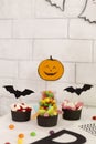 Different scary Halloween candies with paper bats and pumpkin Royalty Free Stock Photo