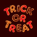 Trick or Treat. Halloween gingerbread cookies on dark chocolate background.