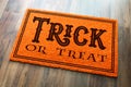 Trick Or Treat Halloween Orange Welcome Mat On Wood Floor Background