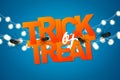 Trick or treat poster or halloween holiday greeting card with typography, spiders, and glowing lights garland on blue bckground. Royalty Free Stock Photo