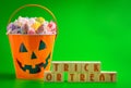 A Trick or Treat SIgn and a Bucket FIlled with Saltwater Taffy Candy Royalty Free Stock Photo
