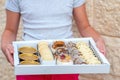 Girl Delivering The Diverse Sweets In A Tray To The Table. Royalty Free Stock Photo