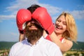 Tricks every woman needs to know. Girl smiling face covers male face with boxing gloves. Cunning tricks to win. Guess Royalty Free Stock Photo