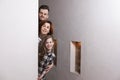 Tricky family peeks around the corner Royalty Free Stock Photo