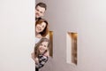 Tricky family peeks around the corner Royalty Free Stock Photo