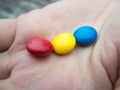 Tricolor bonbons in a hand