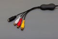 tricolor composite cable with decoder on gray background