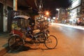 Tricycle bicycle parks on the urban street at nigh