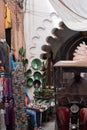 Tricycle cab driving through narrow streets of Marrakech with shops on the street