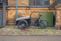 Tricycle cargo family bike with box for the transport of children stands on a street in old town. Copenhagen, Denmark Royalty Free Stock Photo