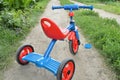 Tricycle kids bike Bicycle blue and red new is on the road in the garden to entertain children Royalty Free Stock Photo