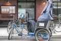 Tricycle taxi pedicab parked on curbside of downtown New York City.