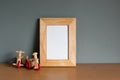 Tricycle wooden toy with light wooden frame mockup on wooden table and grey background. blank space, horizontal image, still life