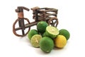 Tricycles with fresh limes on white background