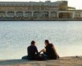 Trieste Italy - harbor, couple relax sitting on Molo Audace pier