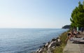 Trieste, Italy - October 1, 2023: Tourists at rocky coast of the Gulf of Trieste