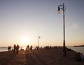 Trieste, Italy - People Stroll Along Molo Audace Pier At Sunset