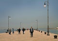 Trieste, Italy - people walk on Molo Audace sea promenade Royalty Free Stock Photo