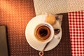 Trieste, Italy - September 2019: Lavazza Espresso cup with Spoon and cookie on a table on a warm summer day in an italian street.