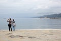 Trieste, September 5 2017, Italy: a couple of tourist taking photos standing on a stone pier Royalty Free Stock Photo