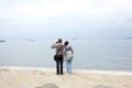 Trieste, September 5 2017, Italy: a couple of tourist taking photos standing on a stone pier Royalty Free Stock Photo