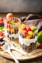 Triffle of chocolate biscuit with yogurt and fresh berries and fruits. Two portioned glass parfafait dessert. Summer healthy diet Royalty Free Stock Photo