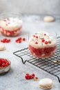 Trifle with red currant and whipped cream in glass