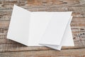 Trifold white template paper on wood texture .