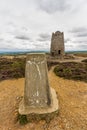 Trig post and derelict stone windmill, Parys Mountain. Royalty Free Stock Photo