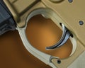 Assault rifle trigger on brown with shadow Royalty Free Stock Photo