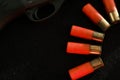 Trigger of a rifle on black background with red lightning with Shotgun shells on a black surface. Ammunition for 12 Royalty Free Stock Photo