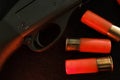 Trigger of a rifle on black background with red lightning with Shotgun shells on a black surface. Ammunition for 12 Royalty Free Stock Photo