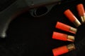 Trigger of a rifle on black background with red lightning with Shotgun shells on a black surface. Ammunition for 12 Royalty Free Stock Photo