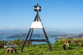 Trigonometrical station on lush green hill overlooking the Wellington harbor on blue sky background Royalty Free Stock Photo