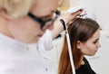 Dermatologist examines a patient woman hair using a special device