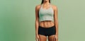 Trim Young Woman In Fitness Clothes On Mint Green Color Background With Empty Space, Full Body. Generative AI