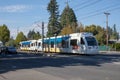 A Trimet light rail train heading through a city near Ruby Junction MAX station, Oregon Royalty Free Stock Photo