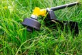 Trimmer for mowing the grass in the garden among the thick grass Royalty Free Stock Photo