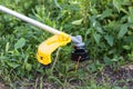 Trimmer with a nozzle with a fishing line for mowing grass Royalty Free Stock Photo
