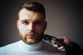 Trimming beard. Man bearded face visit hairdresser. Barber glossy hairstyle. Create style. Macho confident barber cut