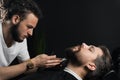 Trimming the beard with a shaving machine. Advertising for barbershop and men& x27;s beauty salon Royalty Free Stock Photo