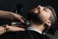 Trimming the beard with a shaving machine. Advertising for barbershop and men& x27;s beauty salon