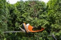 Trimming beautiful green thuja in the garden with an electric hedge saw. Hedge trimming with a professional long blade saw Royalty Free Stock Photo