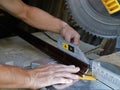 trimming the edge of the floor plinth on a miter saw Royalty Free Stock Photo