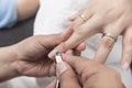 Trimming the eponychium or cuticle with a pair of stainless steel nippers. At a salon or parlor