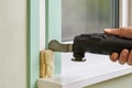 Trimming insulation foam during window installation Royalty Free Stock Photo