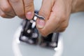 Trims the nail cuticle. A man gives himself a manicure