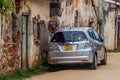 TRINCOMALEE, SRI LANKA - JULY 23, 2016: Modern Hyunday car on a street with dilapidated houses in Trincomalee, Sri Lan Royalty Free Stock Photo