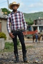 Trinidad, Cuba, August 16th, 2018: Man looking like cowboy walking on the streets of Trinidad