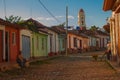 Trinidad, Cuba. The bell tower of San Francisco de Asis. Traditional local Cuban street with houses and the road is paved.